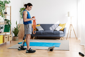 Young man with disability preparing for exercise at home