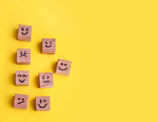 Many cubes with different emotions on yellow background . Empathy and Emotional Intelligence Concept 