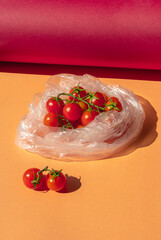 The cherry tomatoes in a transparent plastic bag. Red small tomatoes in a package