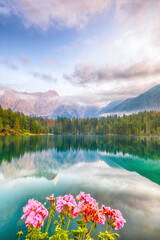 incredible view of sunset over fusine lake with mangart peak on background.