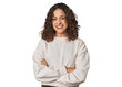 © Asier - Radiant young woman with stunning curls who feels confident, crossing arms with determination.