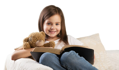 Poster - Cute child girl reading a book in bed before going to sleep