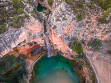 Fototapeta Morze - Waterfall with small lake and turquoise water from above