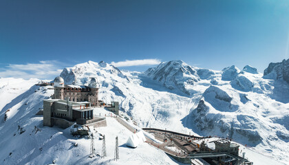 Aerial panorama view of the luxury hotel and the astronomic observatory at the Gornergrat, in the background of the Matterhorn or Cervino mount, Zermatt, Valais, Switzerland, Europe