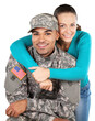 © BillionPhotos.com - Smiling soldier with his wife standing against white background