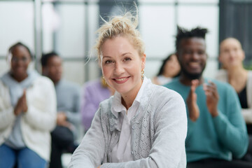 Wall Mural - young attractive business woman, teacher or trainer-mentor, looking at the camera