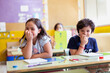 © Alfredo López - Two caucasian children having a fun time at school.  They are happy and smiling in class. Concept of education and child development.