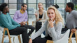 © Katsiaryna - Smiling businesswoman looking at camera at seminar with her colleagues near by