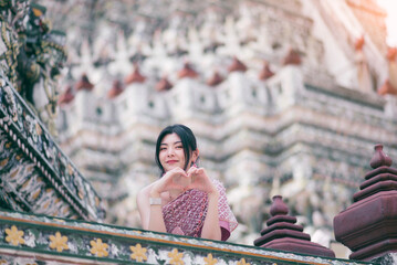 Beautiful Asian girl in Thai traditional costume at temple