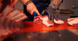 Butcher hands gently cutting raw fresh beef meat ribeye steak. Cook preparing the meat to be seasoned.
