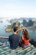 Backpacker couple enjoy trip through south east Asia with stunning view of Halong bay, Vietnam