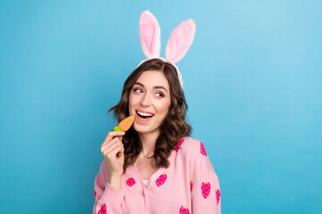 Sticker - Photo of funky dreamy lady dressed pink cardigan easter ears enjoying carrot biscuit empty space isolated blue color background