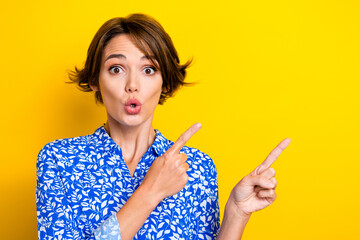 Poster - Photo of funky excited young lady wear print shirt showing two fingers empty space isolated yellow color background