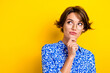 Photo of clever adorable lady wear blue stylish clothes arm face thinking buy new product empty space isolated on yellow color background