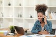 © Treerat - Smart African women working in beautiful office, working on Laptop, use the phone, talking on the cellphone.