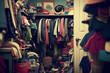 Untidy closet with bunch of messy clothes. Wardrobe in room with thrown clothes on shelf. Created with Generative AI