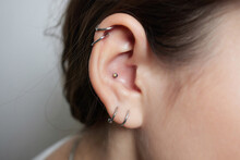 Stretched Lobe Piercing, Grunge Concept. Pierced Woman Ear With Black Plug Tunnel. Industrial And Rook.