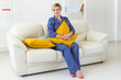 © satura_ - Cute female model in pajama enjoying morning. Pleasant woman sitting on sofa. Good mood
