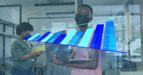 Canvas Print - Animation of data processing on african american woman wearing face mask with laptop at office