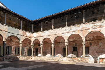 The two story cloister courtyard area of the 14th century Carmine Monastery in the historic Citta Alta upper town district of Bergamo, Italy.