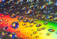 Water Drops On The Surface Of The CD Out Of Focus With Bokeh.