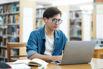 student studying online at library.