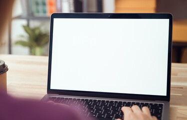 Fototapete - Woman hand type on the keyboard on laptop with mockup of blank screen for the application.