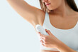 © Goffkein - Woman using deodorant stick for sweating protection