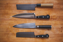 Overhead Close-up Of Various Knives On Cutting Board