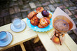 © Cavan Images - High angle view of coffee with desserts on wooden table at backyard