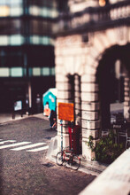 Tilt-shift Image Of Bicycle Parked By Building In City