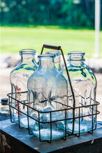 Close-up Of Empty Glass Bottles On Table At Farm