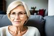 © SOLOTU - Sad tired ill sick lonely disappointed caucasian old elderly senior woman grandmother sitting on the sofa couch, feeling nostalgy, pain, missing grandchildren, bankruptcy, fraud at home. Generative ai