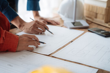 architect  working on table use drawing tool on the paper plan for business architectural project.