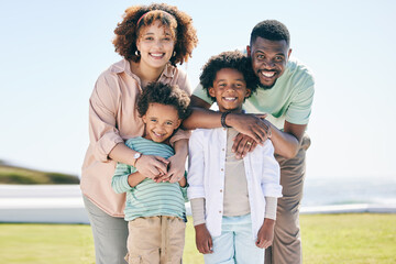 Poster - Love, happy and portrait of a family at the beach on a summer vacation, adventure or weekend trip. Happiness, smile and parents posing and bonding with boy children by the ocean while on holiday.