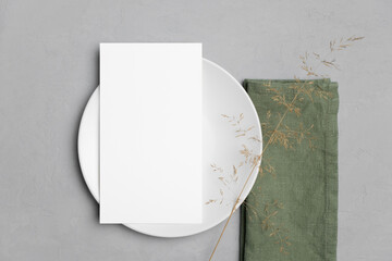 Wall Mural - Wedding paper blank menu card mockup on white plate with botanical decor, mockup with copy space