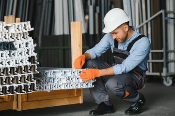 Wall Mural - Portrait of smiling worker standing by industrial production machine.