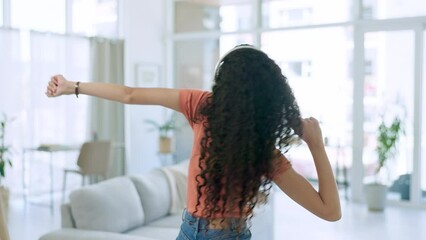 Wall Mural - Dance, music and black woman with headphones in living room for relax, chilling and freedom on weekend. Wellness, smile and happy girl in house listening to song, streaming audio and dancing at home