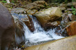© Harmony Video Pro - Beautiful little waterfall in mountains. Water flows between stones