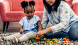 © Art_Photo - Portrait of happy love black family african american mother with little girl smiling activity learn and skill brain training play with toy build wooden blocks board education game at home