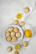 Homemade Italian lemon shortbread cookies with glaze and almond. Shortbread citrus biscuits on white stone background