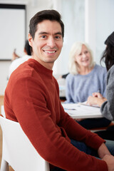 Smiling man sitting at workshop