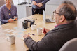 © Johnér - Mature man listening during business meeting