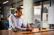 © JustLife - Portrait of businessman in office. Man using digital tablet. Businessman having video call.