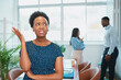 © Meeko Media - Young Black woman looks upset while colleagues talk behind her back office drama