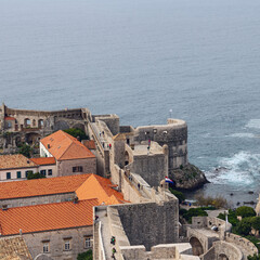 Wall Mural - fortress walls, red roofs of houses and a quiet bay in the Croatian city of Dubrovnik