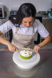 © Alfonso Soler - Colombian pastry chef cuts cake in half with Japanese knife