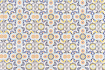 Old traditional ceramic azulejos tiles pattern on the house exterior. Abstract colorful floral geomtric background.