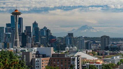 Poster - Skyline view of downtown Seattle from park with Mount Rainier in the distance during a sunny and cloudy day