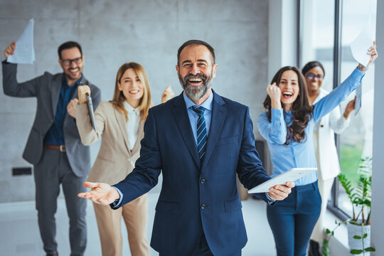 euphoric excited business team celebrate corporate victory together in office, happy overjoyed profe